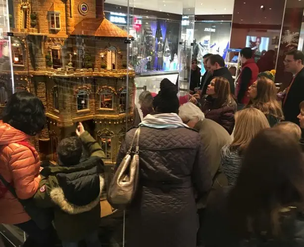 Visitors pressing close to the glass to view the castle's rooms