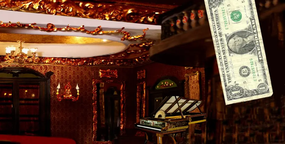 Ornate gilded ballroom with a harpsichord, next to a dollar bill for scale