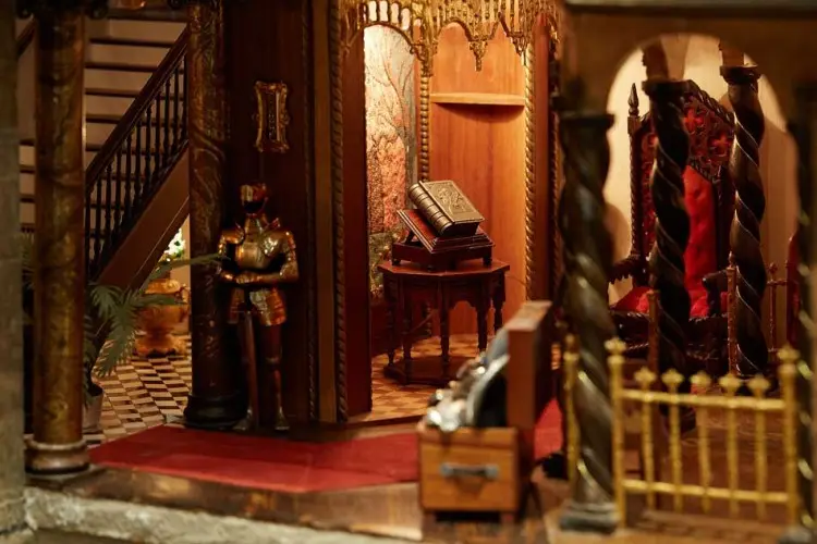 Great hall with a suit of armour, a carved staircase and a lectern