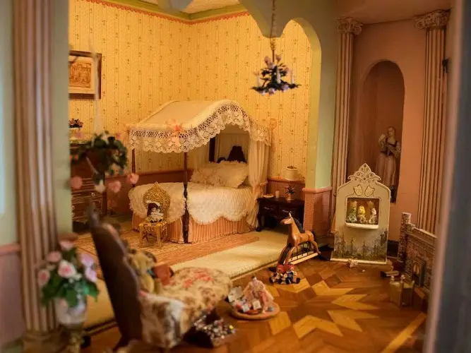 Nursery with a lace canopy bed, a rocking horse and parquet floor