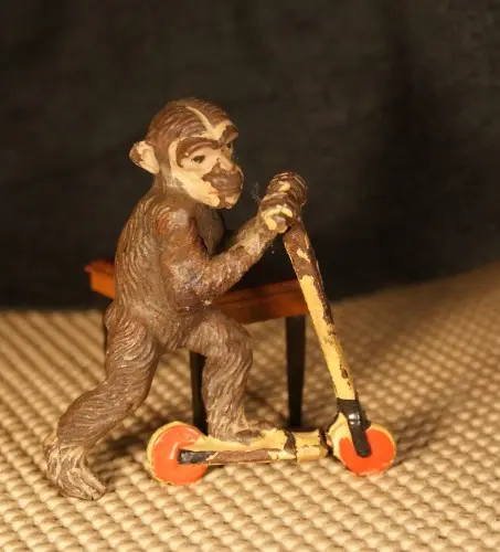 Bronze monkey riding a tiny scooter